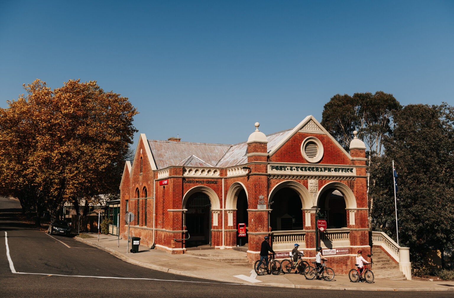 Family cycling in Omeo near Old Post Office