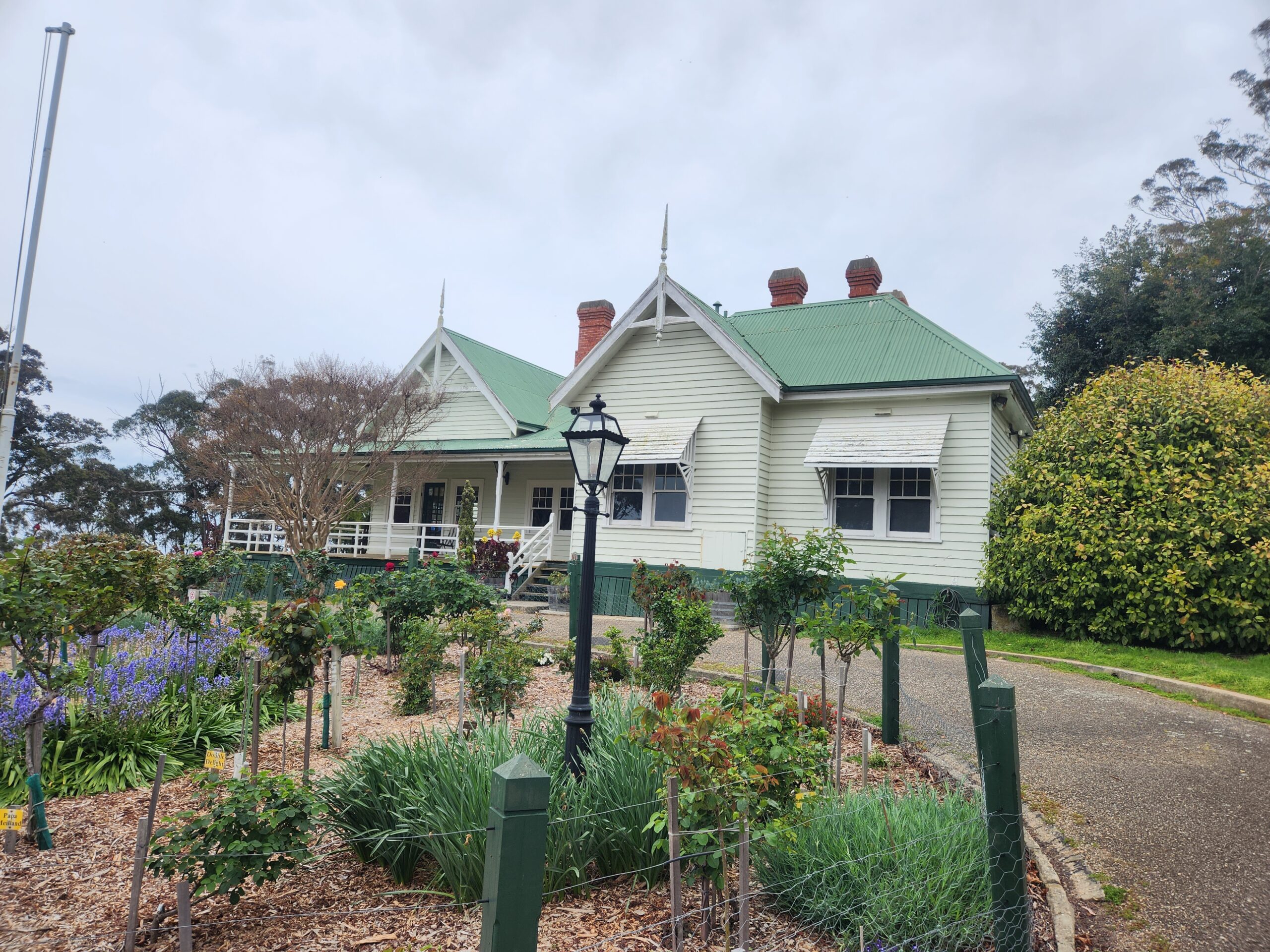 Main house at Nyerimilang with rose garden in front, East Gippsland heritage site.