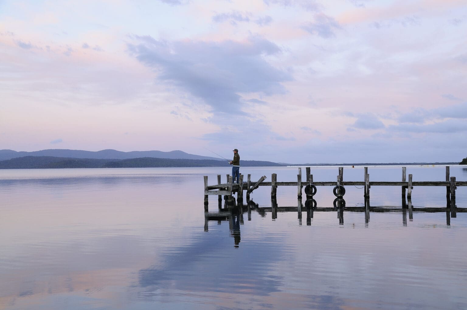 Fisherman on pier at Mallacoota